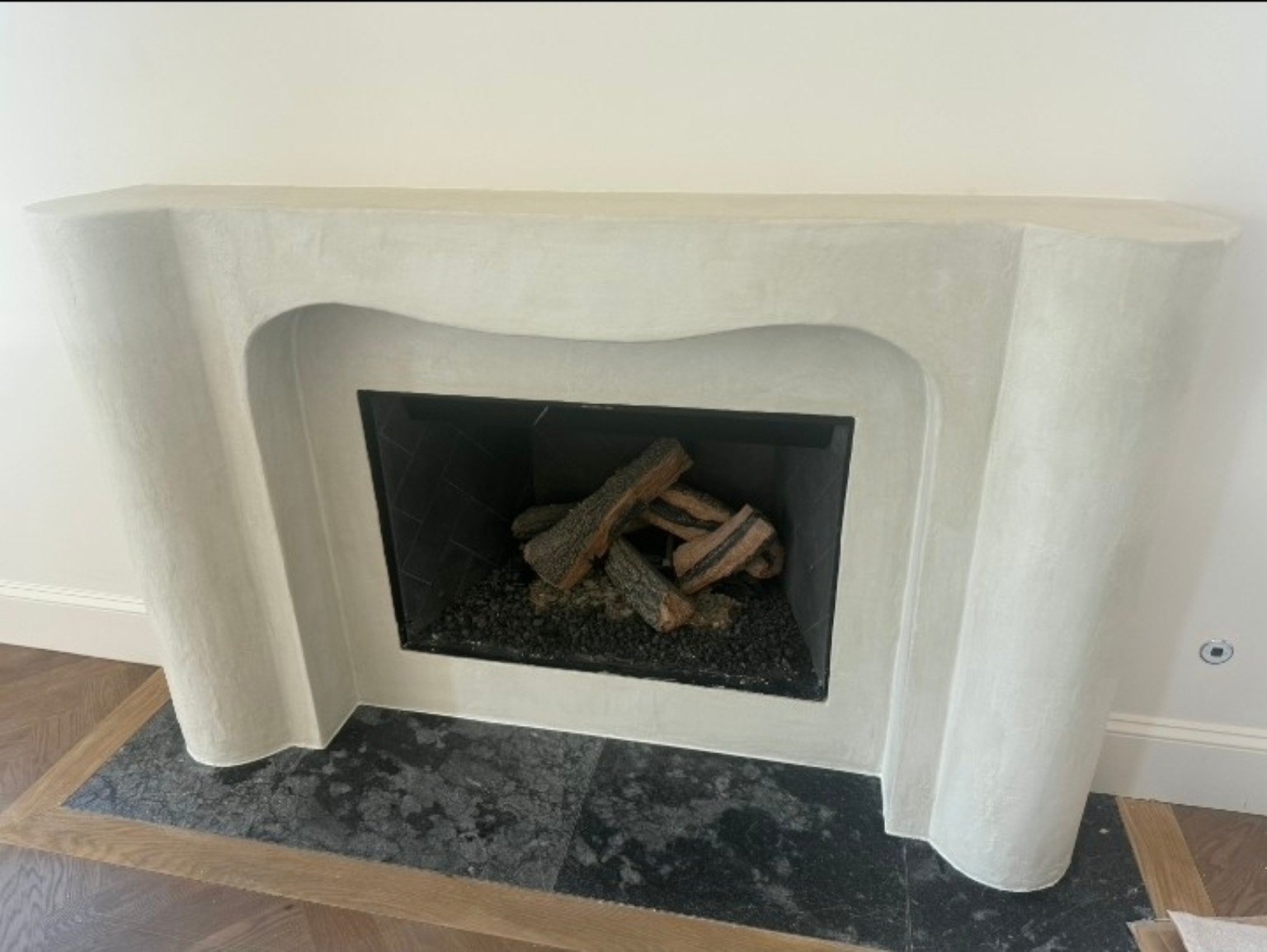 White fireplace surround with custom mantel and built-in shelving